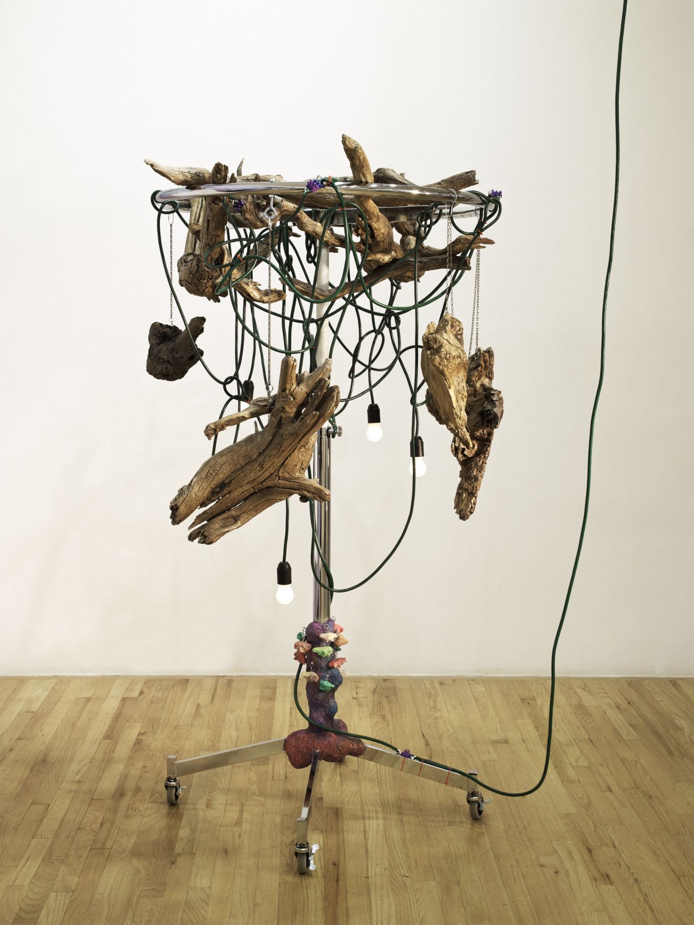 Haegue Yang Wild in Aspen: Giant Fingers, 2011 Round clothing rack (chrome) on casters, light bulbs (frosted), electric cable,chain, nylon cord, key rings, varnish, shower curtain holders, papier mache, and driftwood 75 1/4 x 45 x 44 5/8 inches 191.1 x 114.3 x 113.3 cm