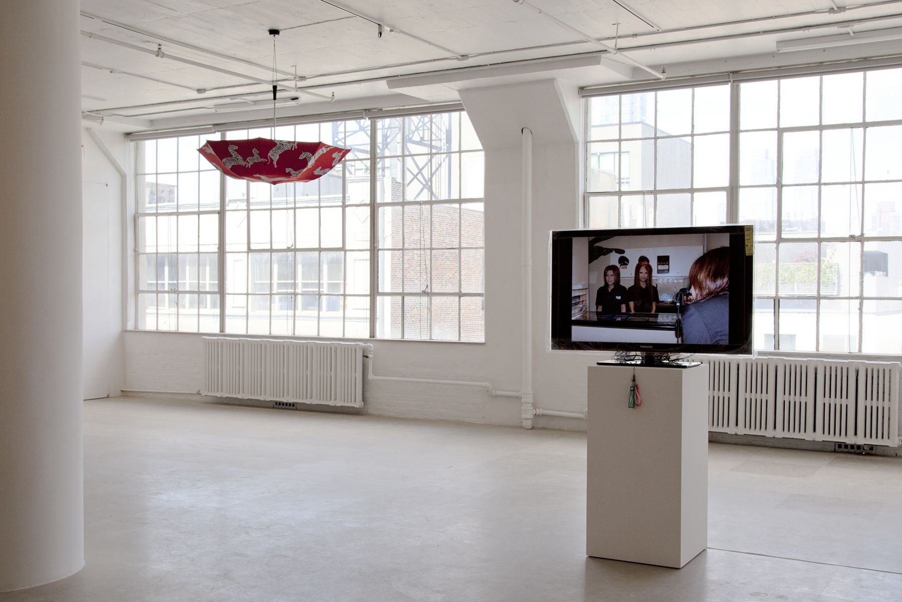 Ei Arakawa / United Brothers (w/ Das Institut), BLACKY Blocked Radiants Sunbathed, 2011, Digital projection of 185 slides with a set of mobile straps, Dimensions variable, Ed. 1/3, 2 APs, Installation view, Greene Naftali, New York, 2011