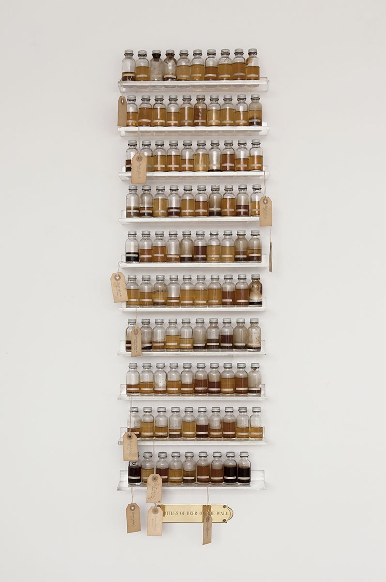 Candy Jernigan, 99 Bottles of Beer on the Wall, c. 1988-89, Beer, glass vials, packing tags, and Plexiglas shelves, 48 x 14 x 3 1/2 inches (121.9 x 35.6 x 8.9 cm)