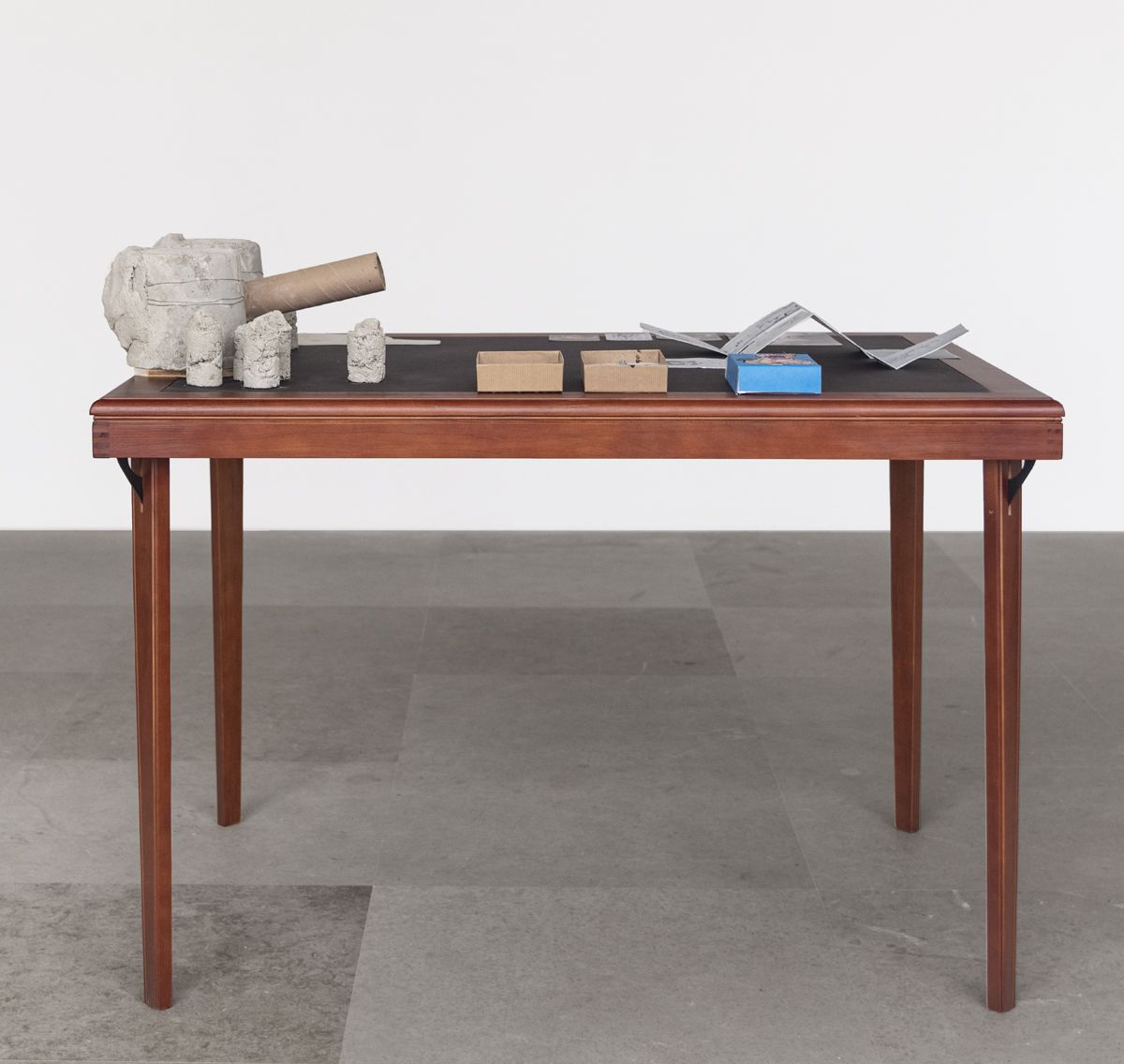 After Artaud: The sexual awkwardness of god, Ass Cannon, 2019, Concrete, cardboard tube, boxes, razors, tacks, matches, mousetrap, corkscrew, office hardware, pubic hair, cow’s blood and collage on table, 36 x 45 x 32 inches (91.4 x 114.3 x 81.3 cm)