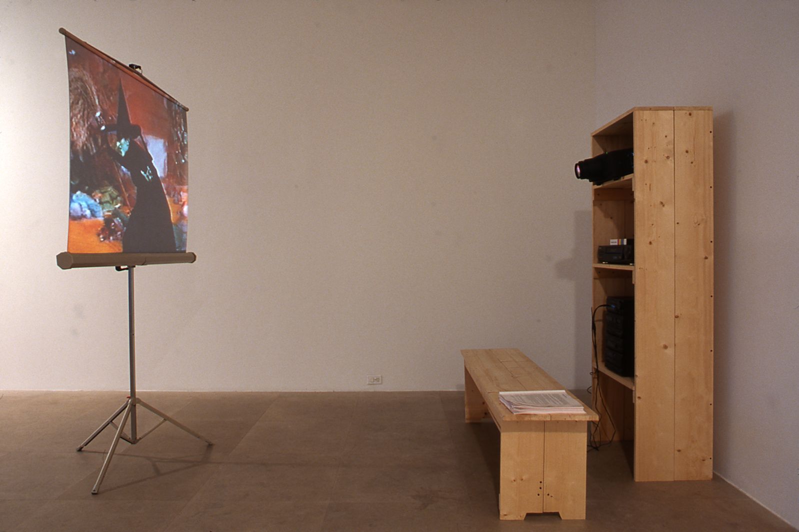 Julie Becker, Suburban Legend, 1999, 1 Beta Master tape, 1 vhs viewing copy, 1 metal homemovie screen, 1 vcr with time clock, 2 headphone sets, wood shelf unit and bench, 3 Suburban Legend manuals