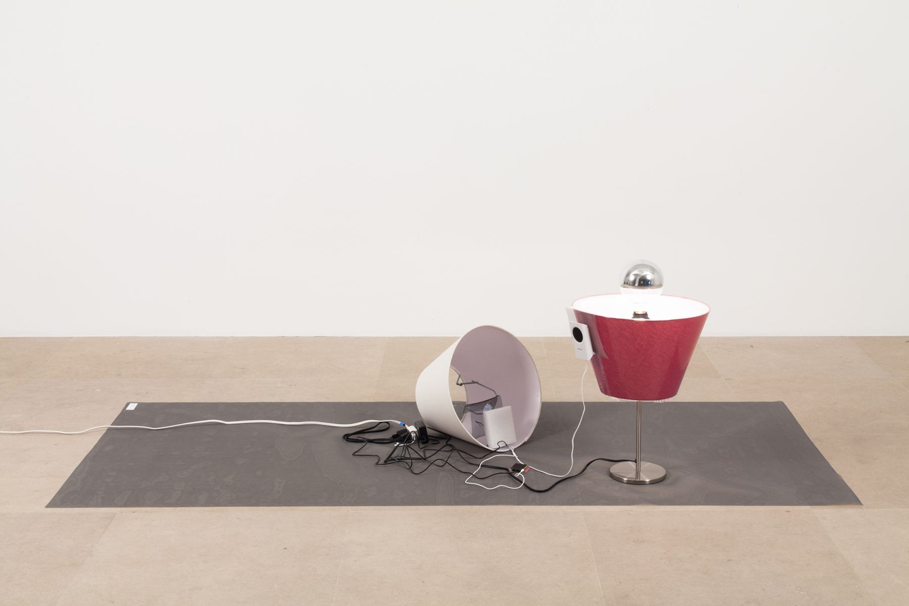 Josef Strau, The Inner Voices Working, 2012, Poster, 2 lamps, sound on iPod, 2 speakers, dvd with 19 slides, and wire mesh, dimensions variable