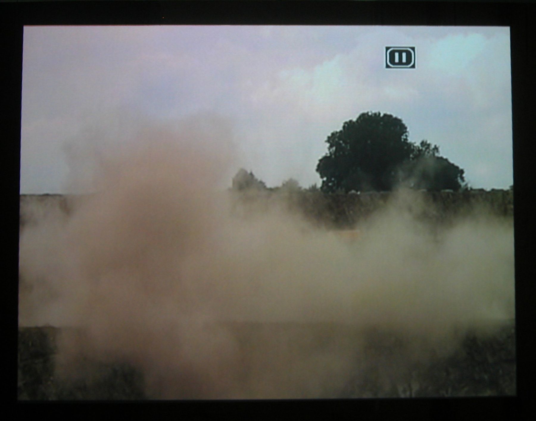 Quarry, 2003 (still), Two Parts: “Blast” (4 minutes), “Dr. Chris Alabaster” (12 minutes), 2 DVDs, bleachers, wooden screen, Installation dimensions variable