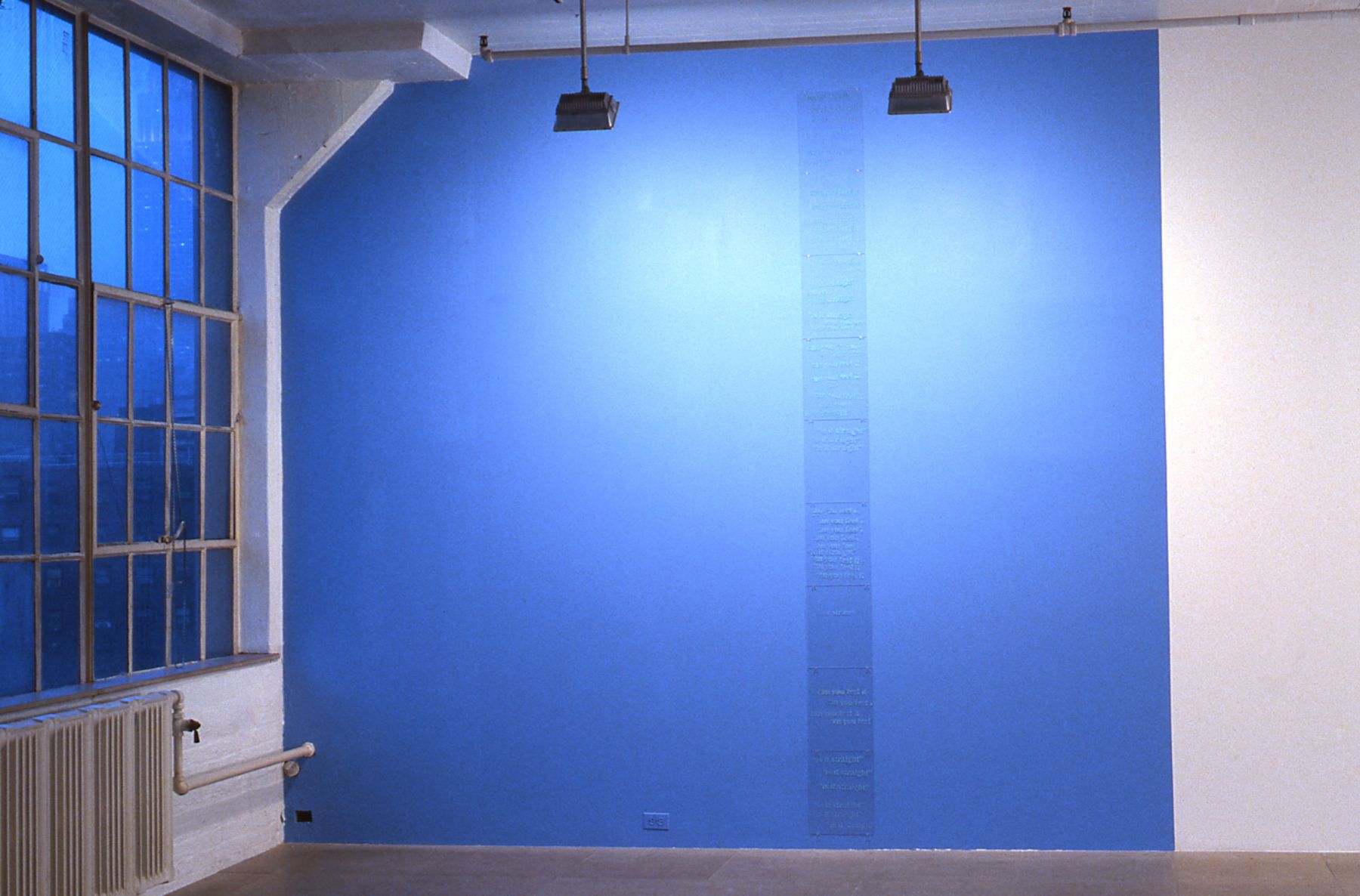Mark Bradford, Lot's Wife, 1997, 9 plexiglass pieces with text, 11 x 14 inches; sky blue painted wall, dimensions variable