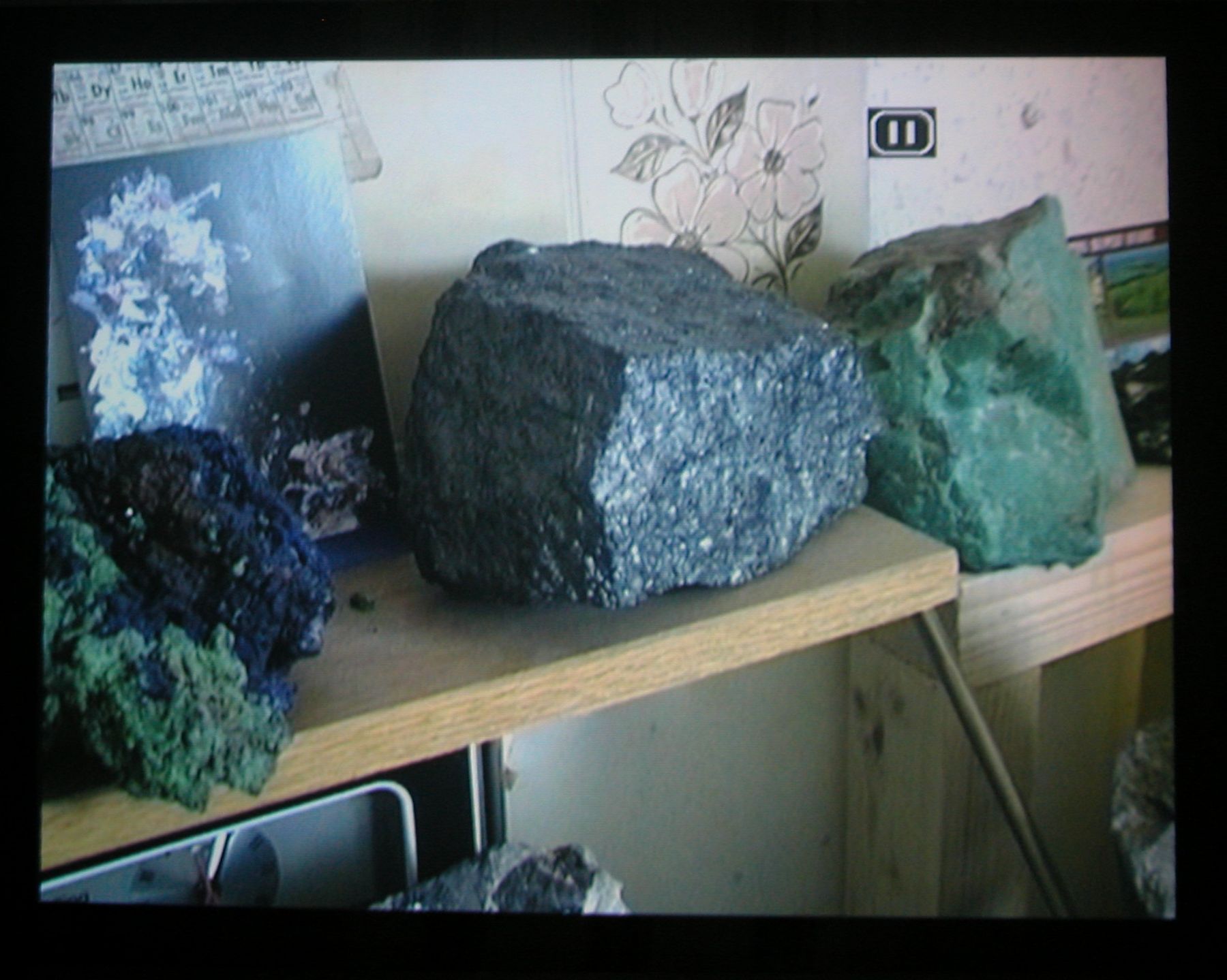 Quarry, 2003 (still), Two Parts: “Blast” (4 minutes), “Dr. Chris Alabaster” (12 minutes), 2 DVDs, bleachers, wooden screen, Installation dimensions variable