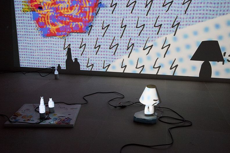 The Story of Painting, 2012, 3-D video slideshow with 3-D glasses, two acrylic-on-canvas paintings, computer speaker, lamp, painted bottles and painted foam pieces, 19:01 min, color, sound, Dimensions variable