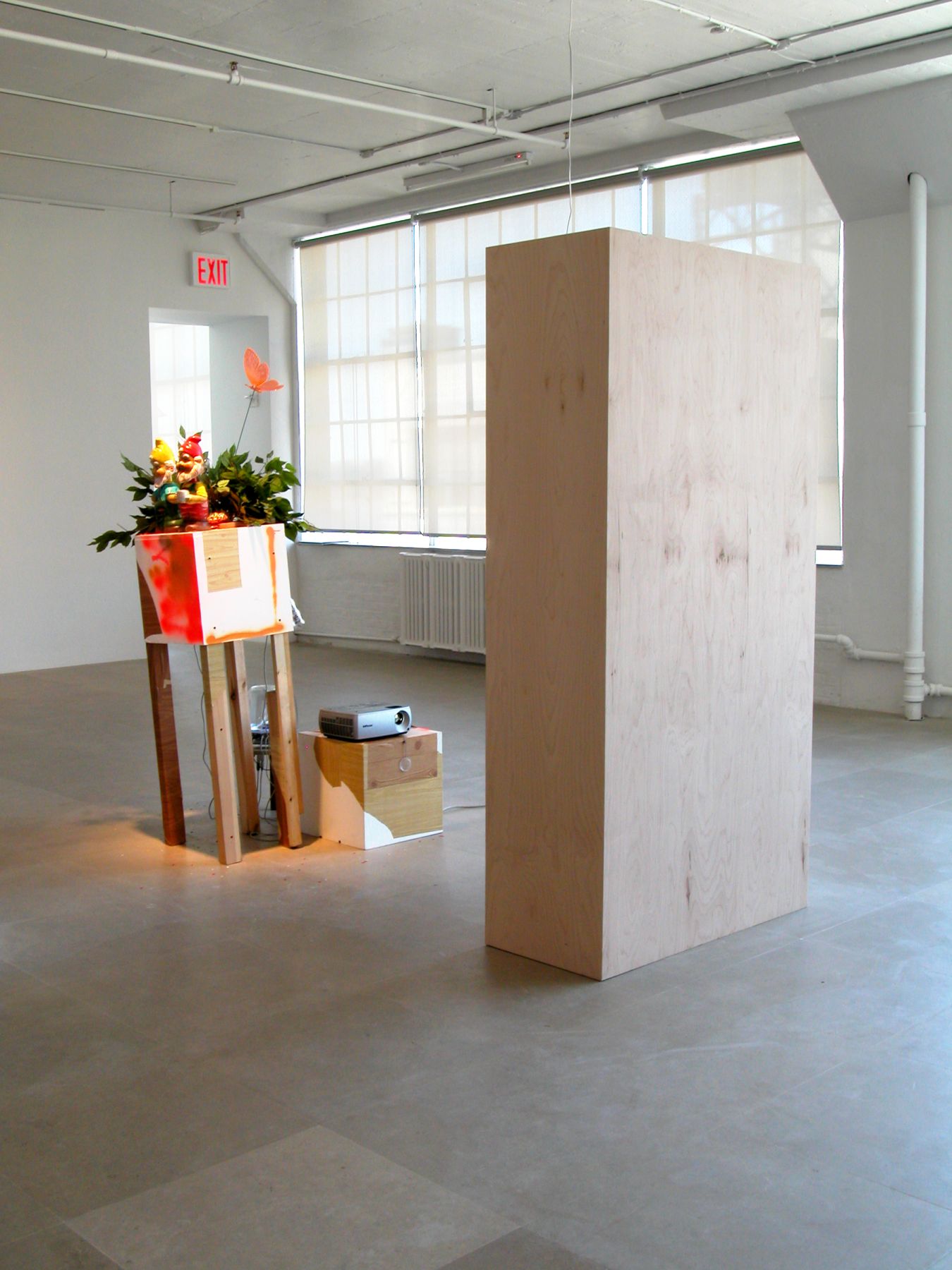 Rachel Harrison, Double Vision, 2006-2008, wood, shelf liner, metal, plastic, fake foliage, confetti, DVD player, projector, apple sound sticks, Simon LeBon mirrors, 78 x 36 x 18 inches