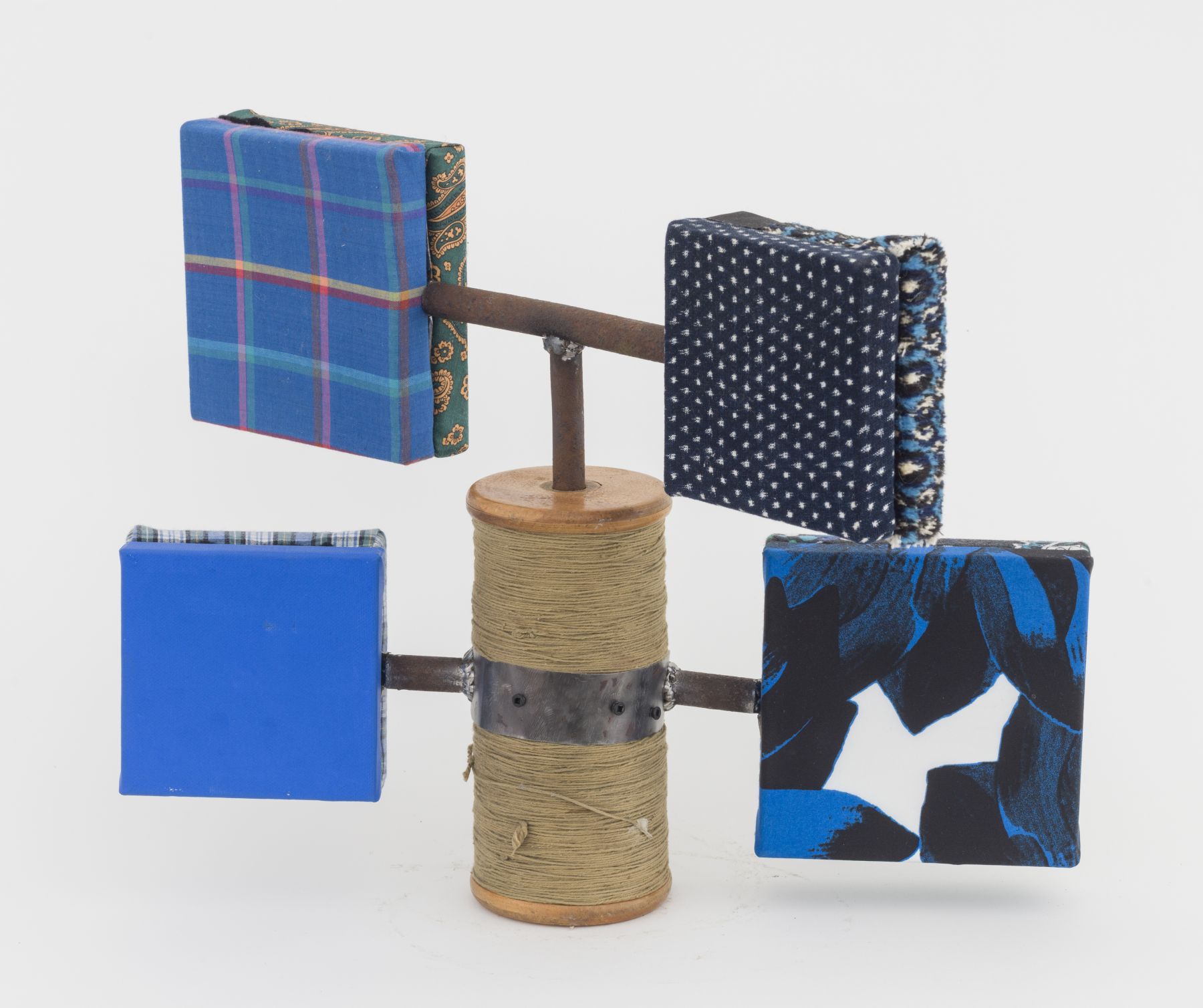 Sentinel, 2018, wooden blocks, fabric, found spool, plumbing parts