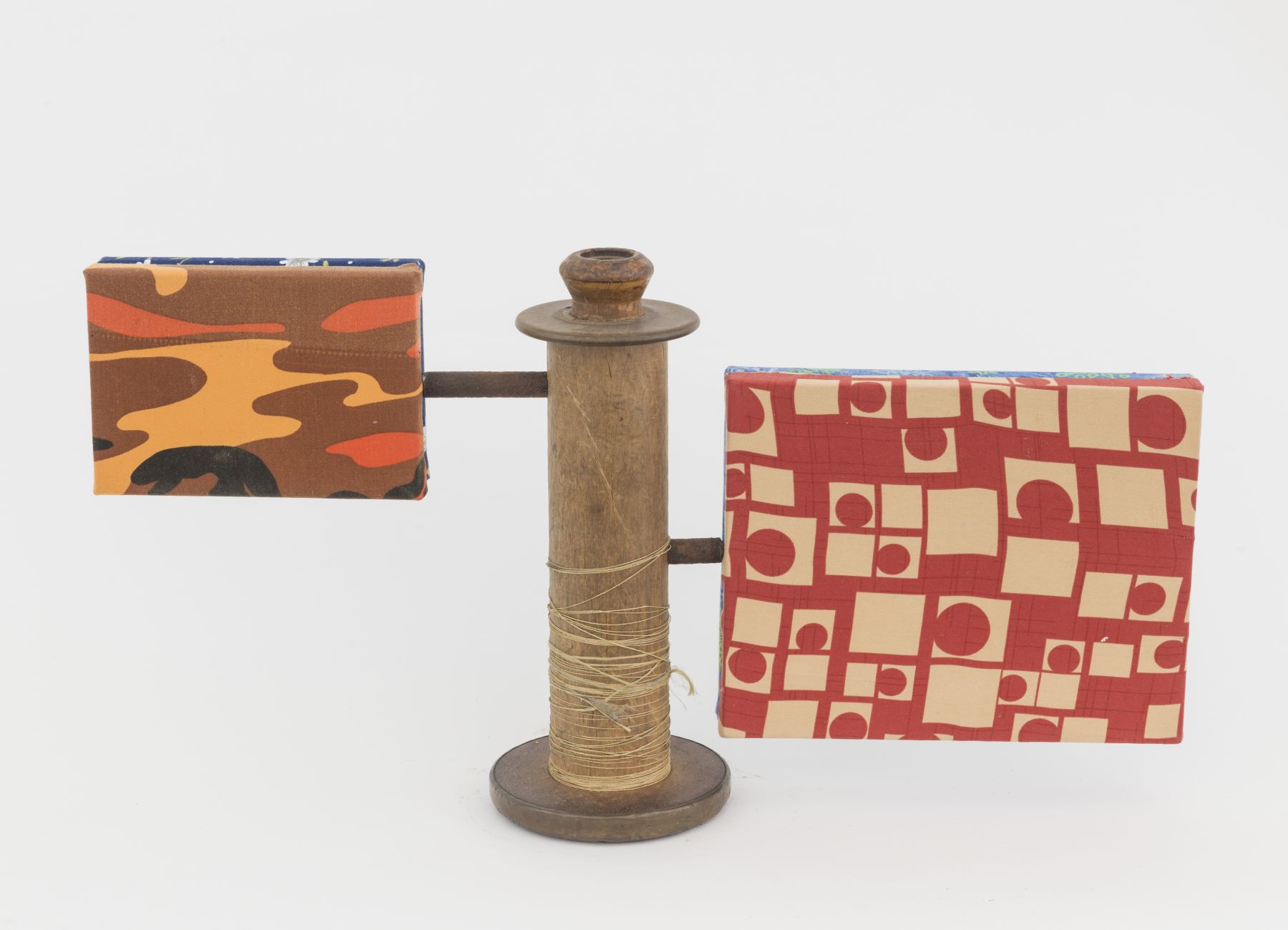 Sentinel, 2018, wooden blocks, fabric, found spool, plumbing parts