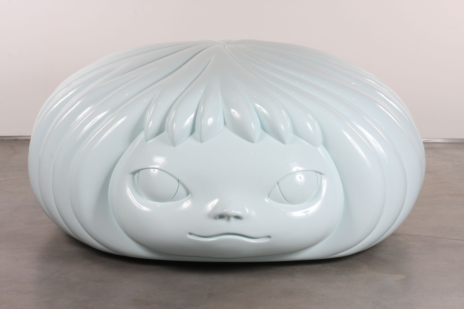 sculpture of a flat female head by yoshimoto nara