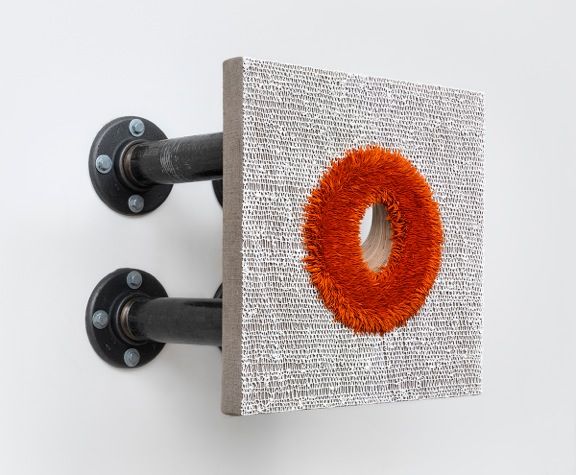 a glory hole painting by donald moffett that is extended from the wall by black pipes