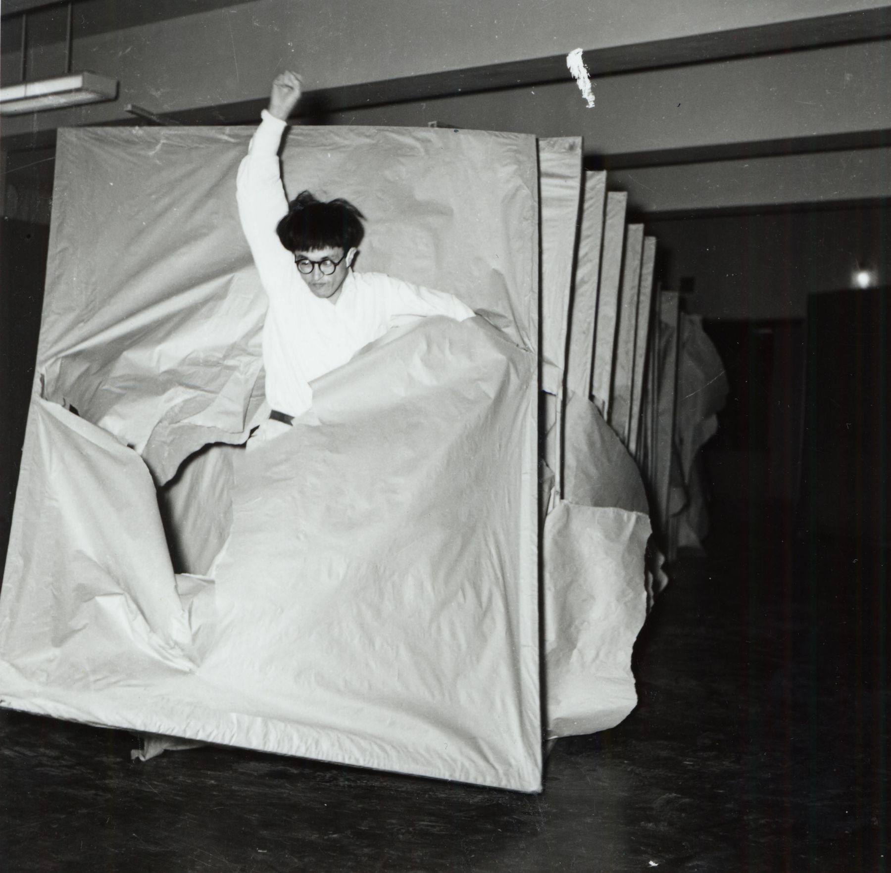 photograph of a man running through a structure by saburo murakami
