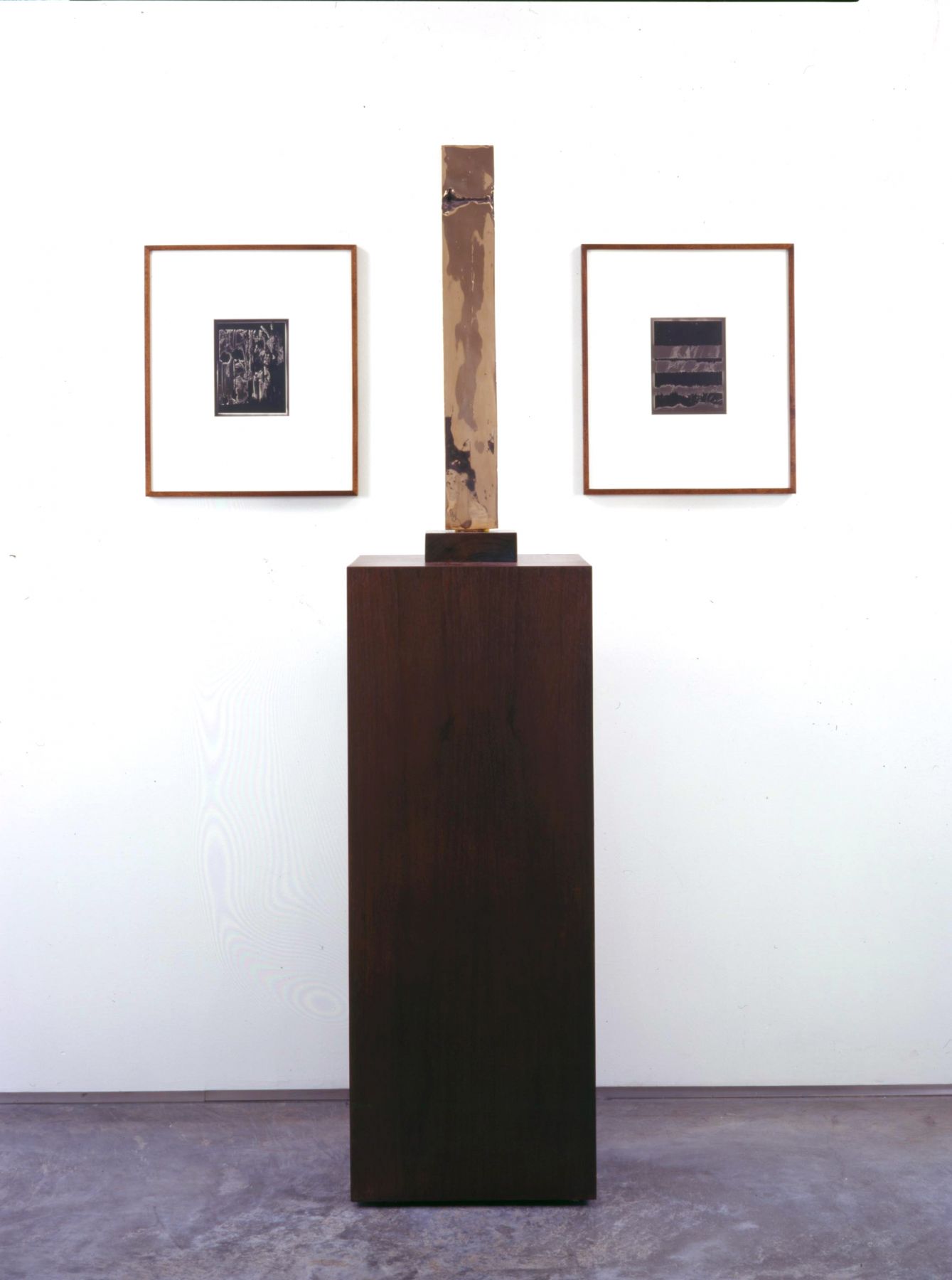 installation by anthony pearson with rectangular sculpture flanked by two photographs