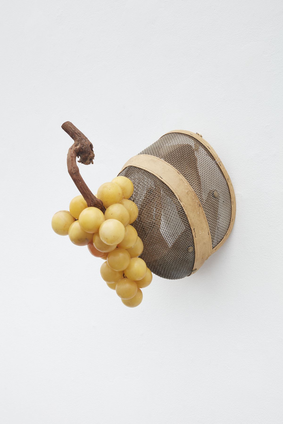 Fencing mask with round objects attached viewed from a side angle by Allison Janae Hamilton