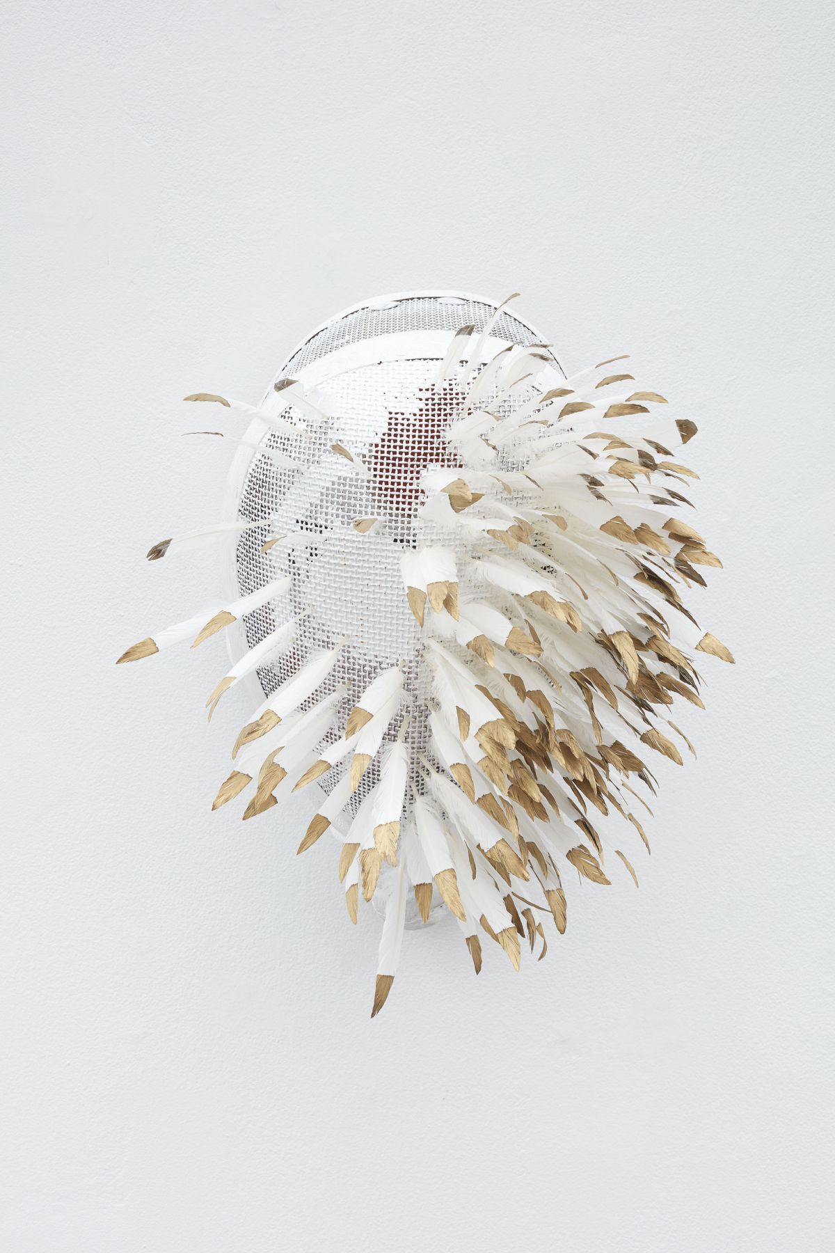 Fencing mask with gold tipped feathers inserted by Allison Janae Hamilton