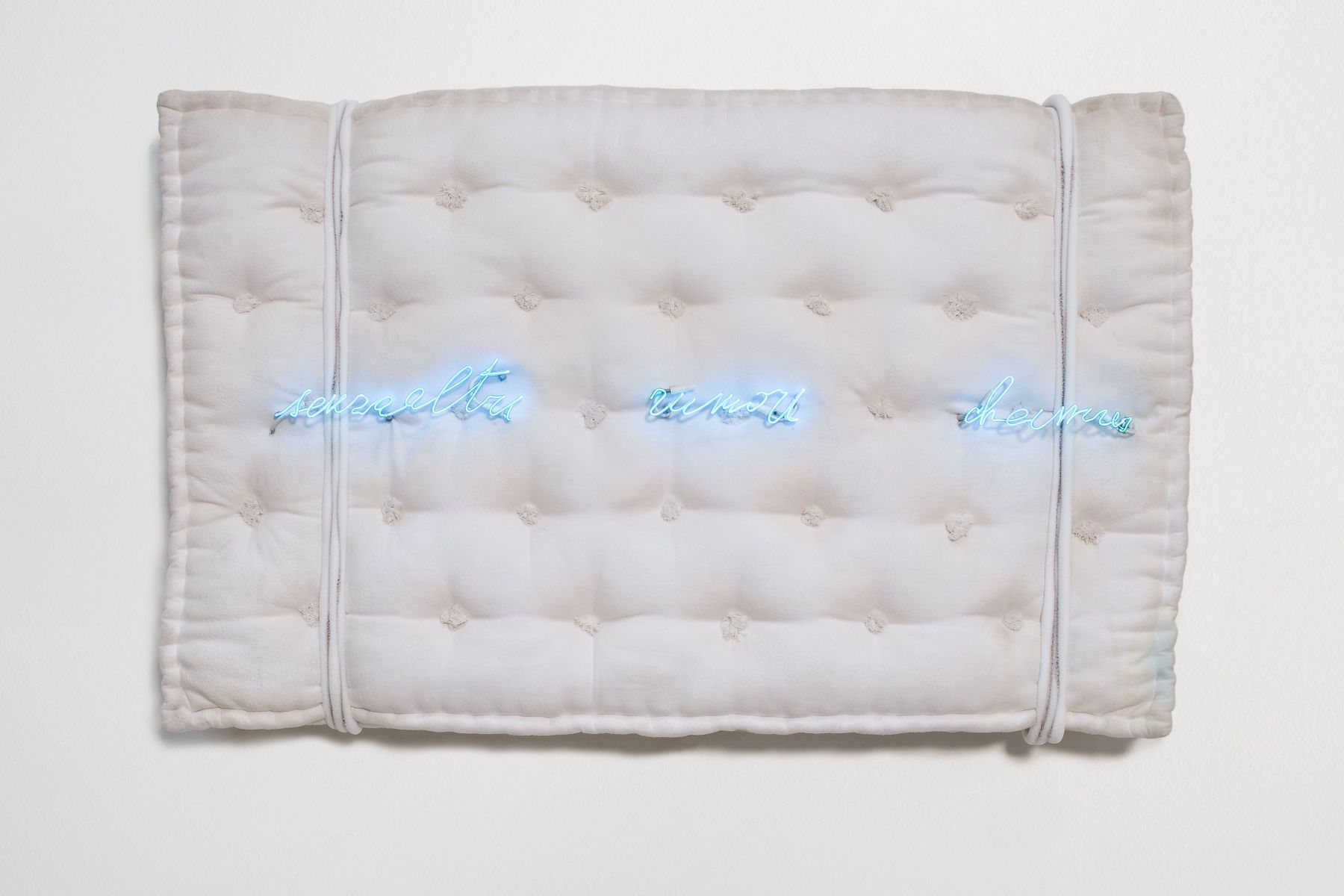 mattress with neon letters by pier paolo calzolari