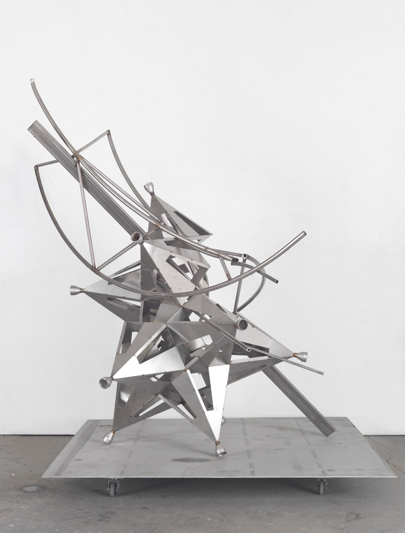 a deconstructed star sculpture of metal by Frank Stella in a chelsea contemporary art gallery