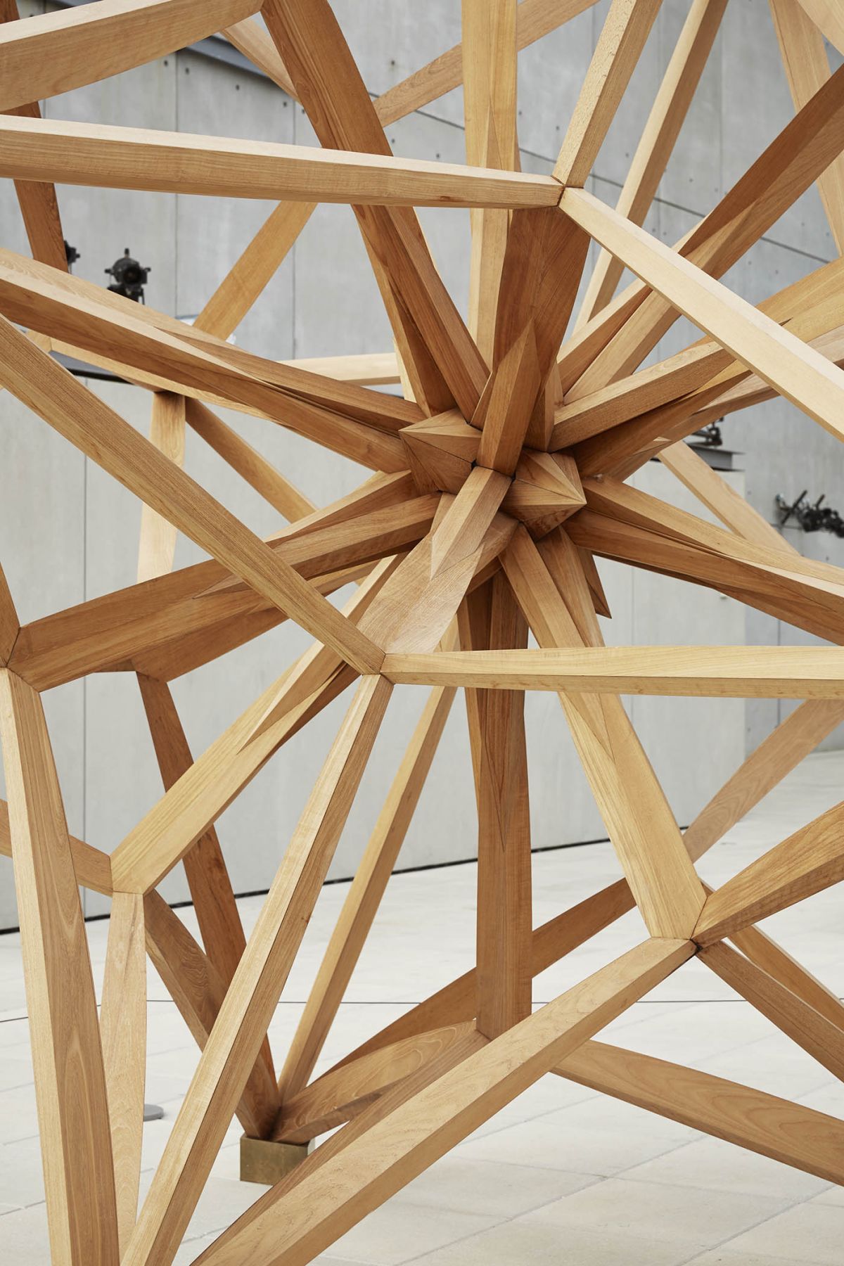 A detail of a wooden star made out of teak by frank stella