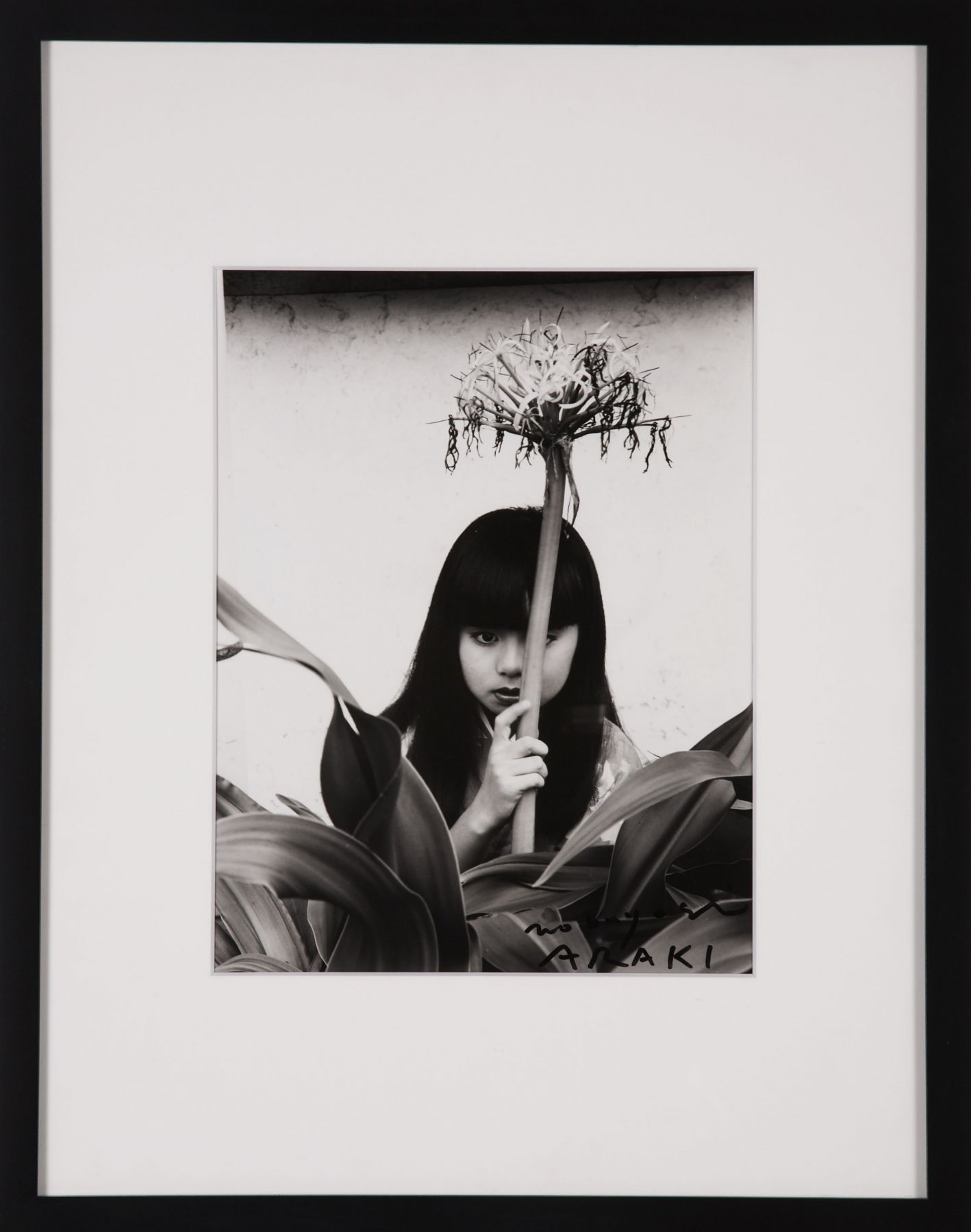 photo of a girl with a flower by nobuyoshi araki