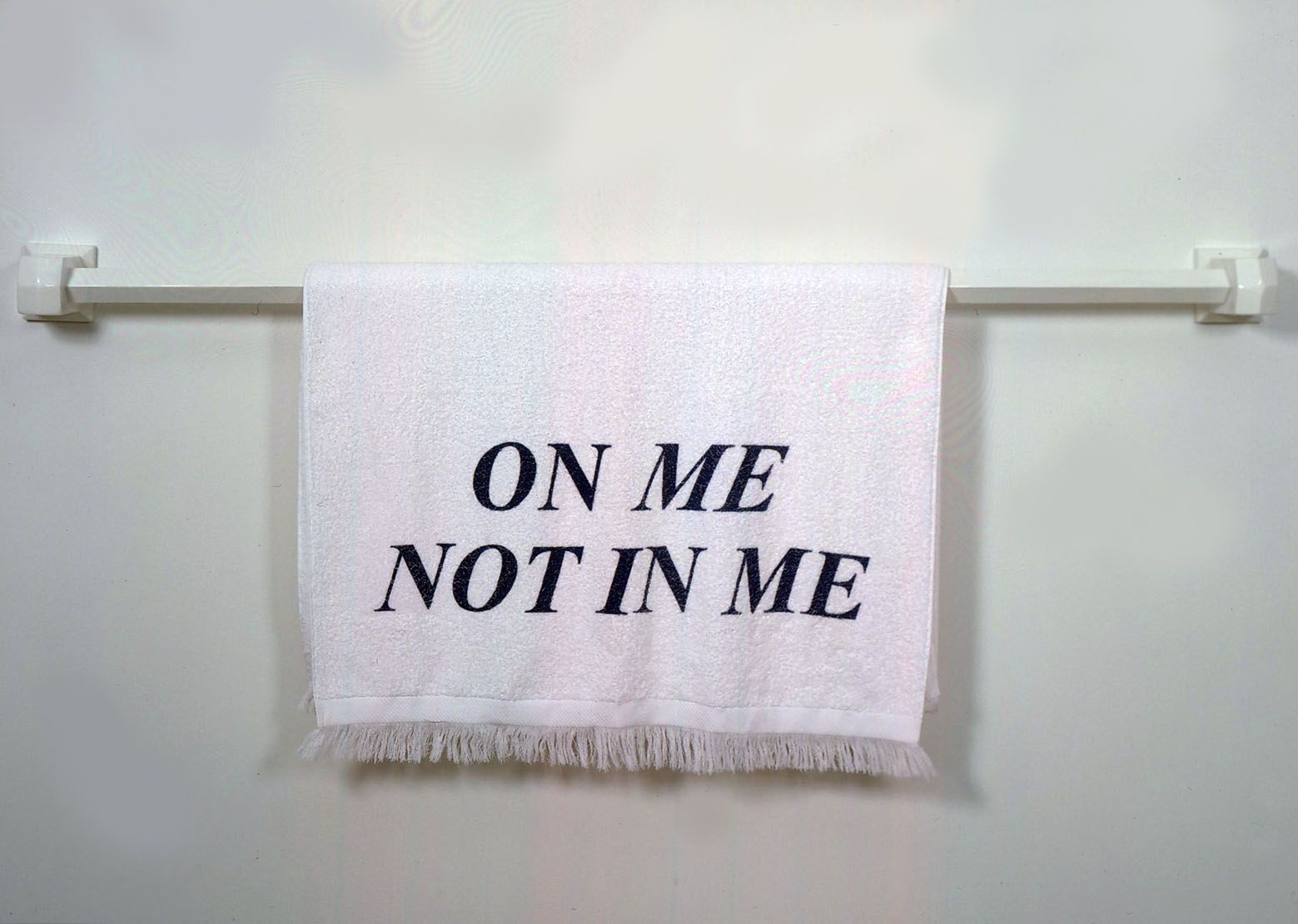 towel on rack with "on me not in me"
