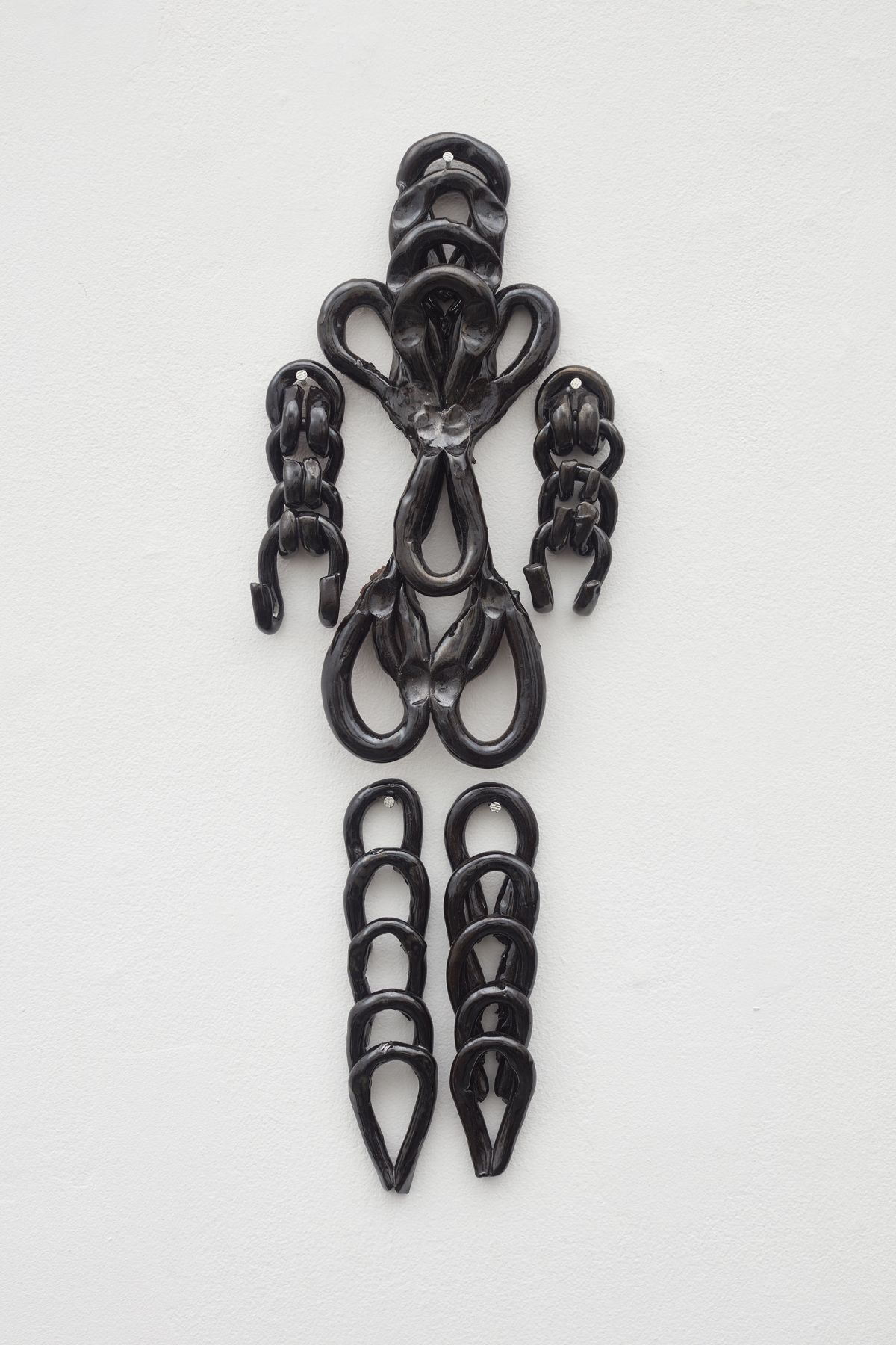 Wall hanging ceramic work of a human figure by ektor garcia