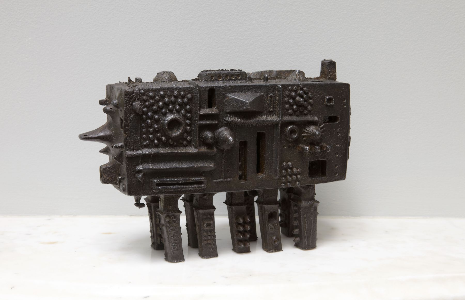iron sculpture with legs and protrusions by julius smith