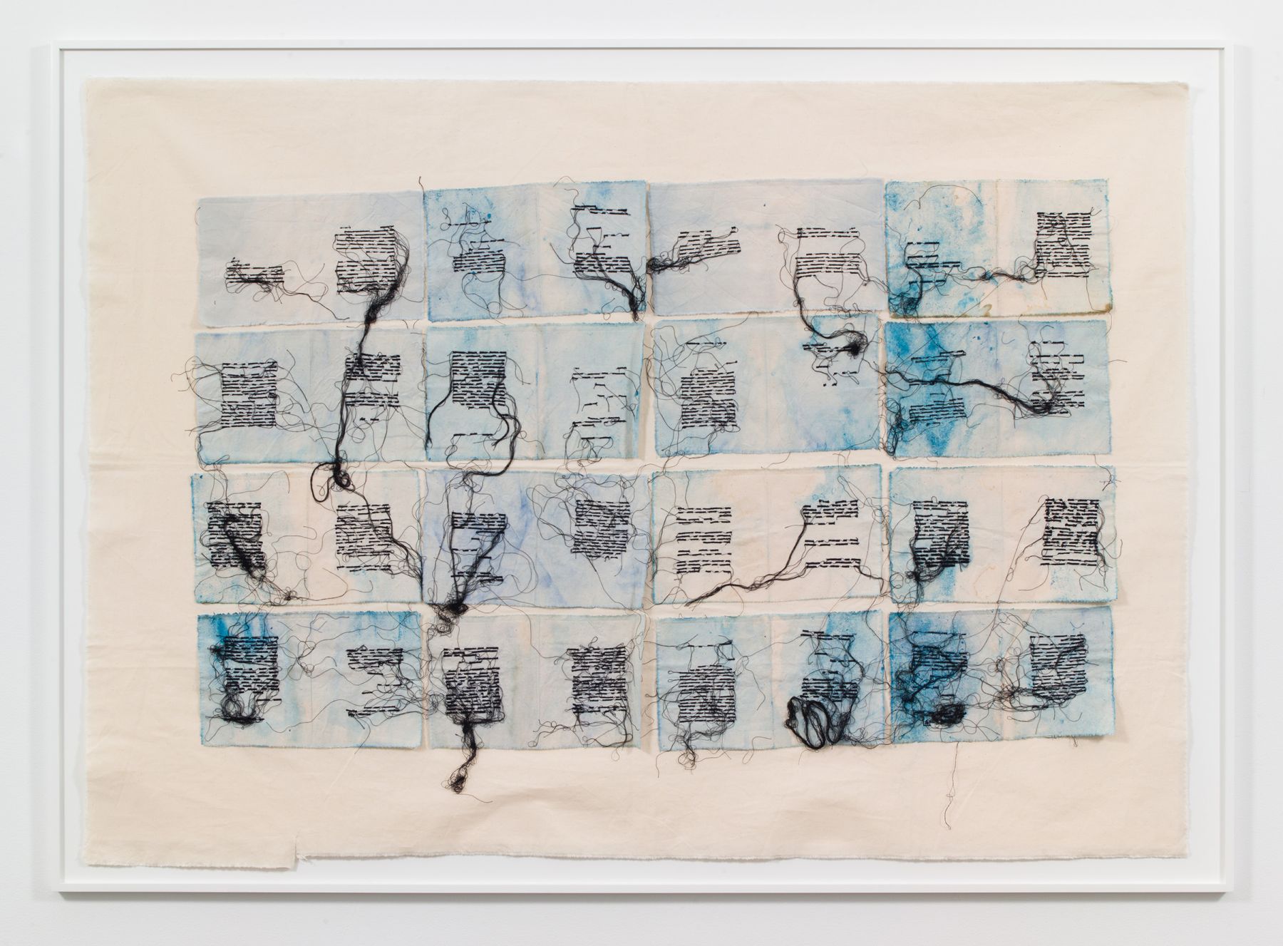 a framed textile work with embroidery mimicing text on pages by Italian female artist Maria Lai