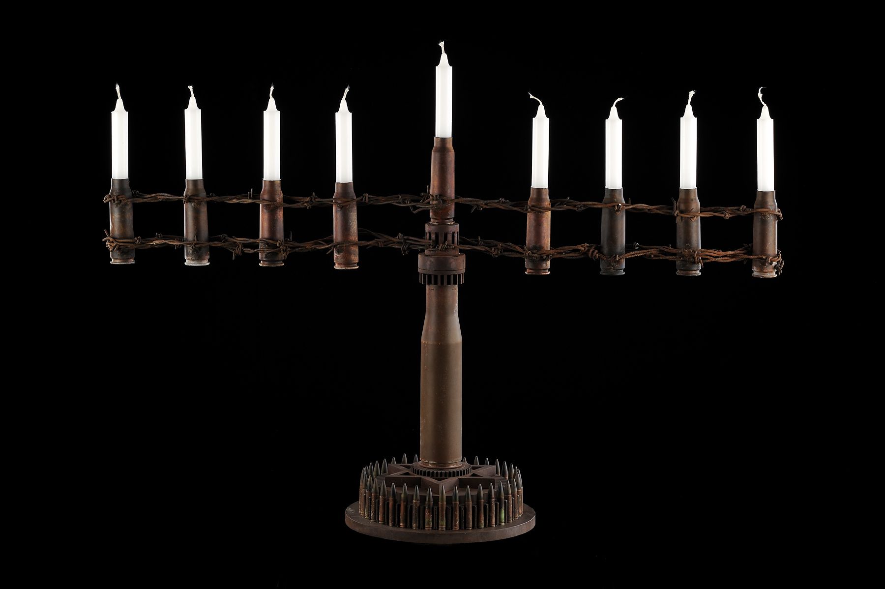 Al Farrow, Menorah (Fence II), 2011, shell casings, barbed wire, steel, 23 x 32 x 10 inches