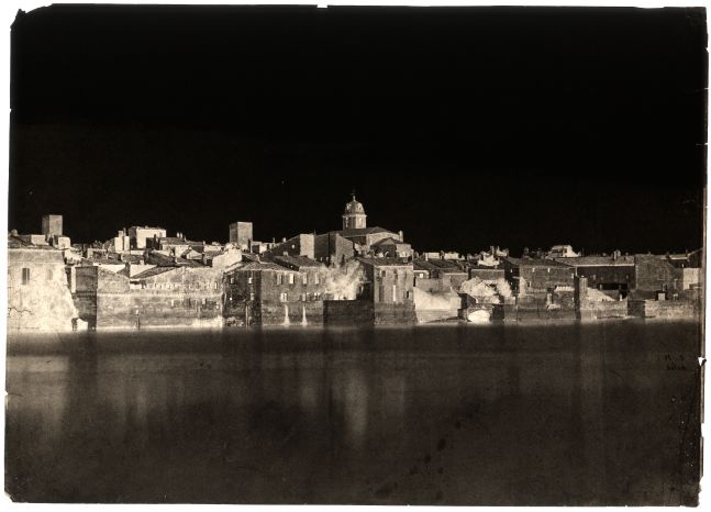 Charles NÈGRE (French, 1820-1880) View from the banks of the Rhône "Arles", 1852 Waxed paper negative with selectively applied pigment 23.7 x 33.1 cm Initialed "C.N." and titled "Arles." in black ink on verso