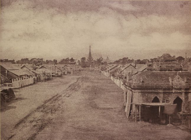 Captain Linnaeus TRIPE (English, 1822-1902) "No. 71. Amerapoora. A Street leading to the Palace.", 1855 Albumenized salt print from a waxed paper negative 25.4 x 34.7 cm mounted on 45.6 x 58.3 cm paper Signed "L. Tripe" in ink. Photographer's blindstamp and printed label with plate number, title and "The Ooh-nein gate leads into this street. The Palace is the centre of the city, and the streets leading from the central gate of each face converge on it." on mount.