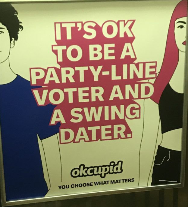 OK Cupid ad showing a masculine figure in a blue shirt and a feminine figure with pink hair, with text reading "Its ok to be a party-line voter and a swing dater."