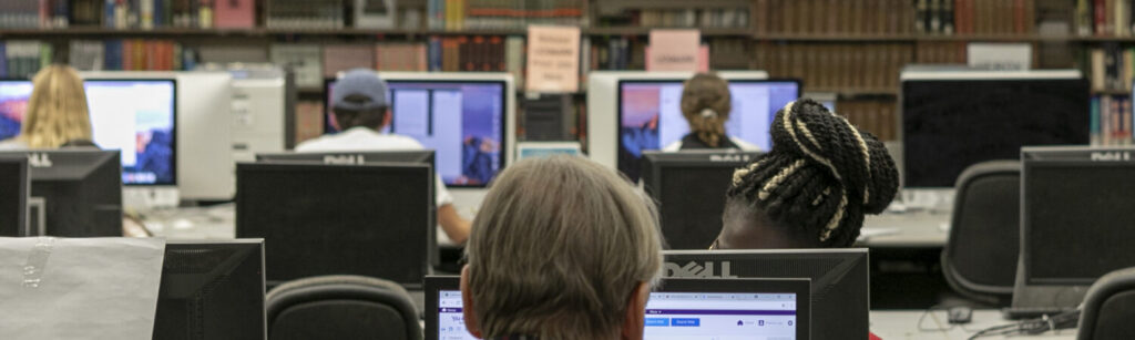 People at computers in the library