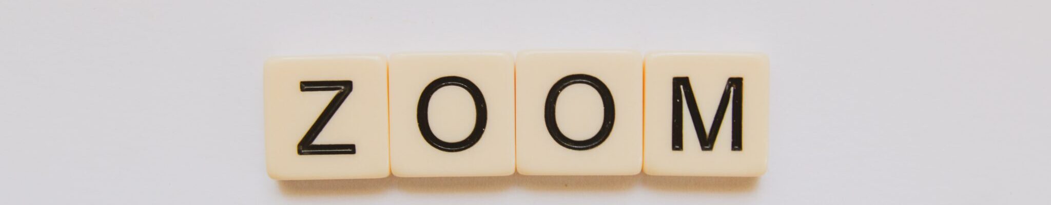 The word "zoom" spelled with Scrabble tiles
