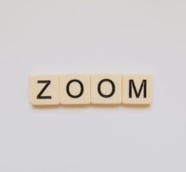 The word "zoom" spelled with Scrabble tiles