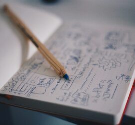 A pencil sitting on a notebook