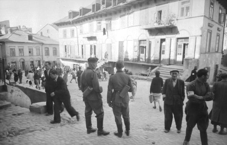 people walking and two german soldiers watching them