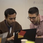 students looking at laptop screen together