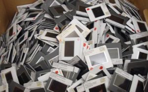A messy pile of 35mm slides in a box