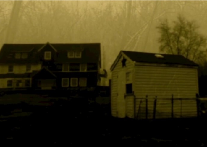 Two rural buildings dimly photographed in sepia tone.