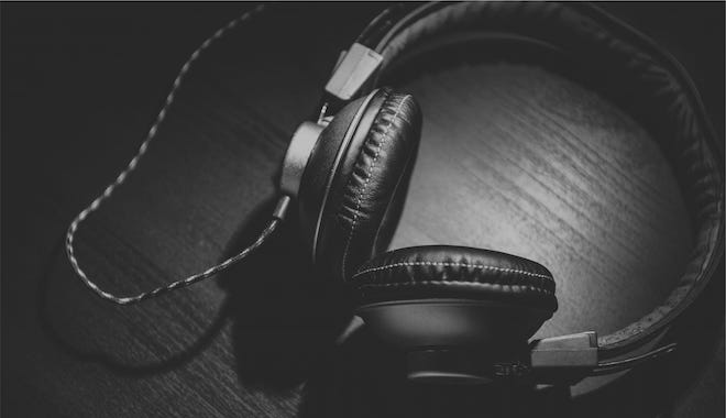 Black headphones on black woodgrain surface