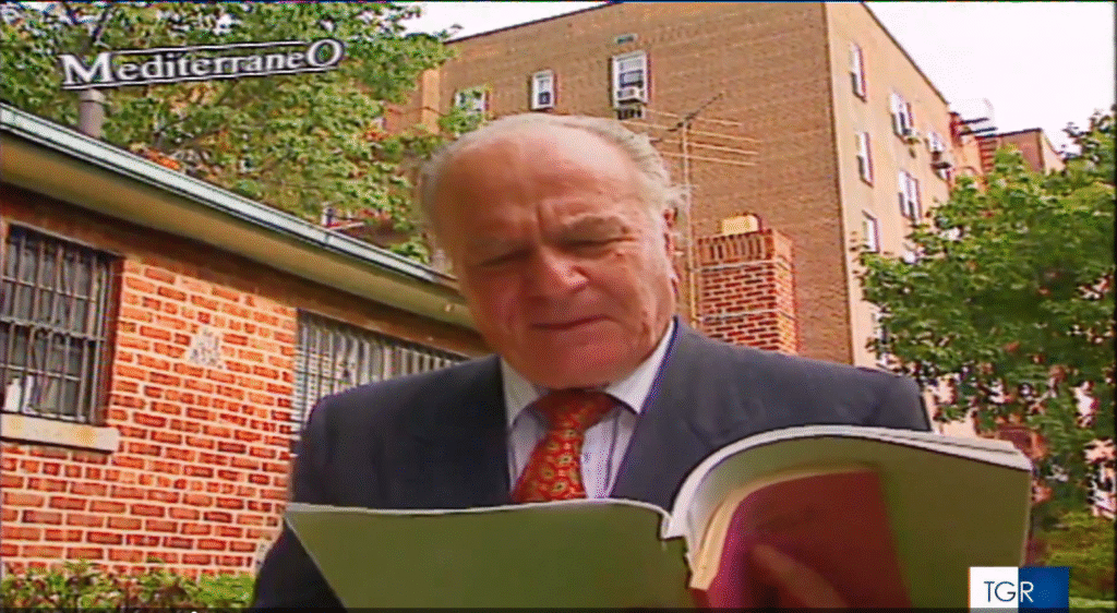 Still image from a video of Joseph Tusiani, in the Bronx, walking and reading books