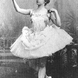 Bluebeard_-Olga_Preobrajenskaya_(Anne)_1896 Black and white photo of a ballerina in a tutu with a raised arm on which a white bird perches