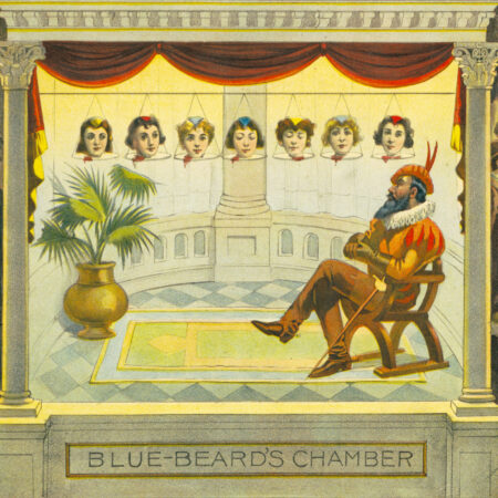 Roltair_Illusion_-_Blue-beard_chamber An image of a columned stage, from a horizontal pole, the heads of seven women are hanging. Bluebeard sits in a chair on the lower right in Renaissance clothing with a fencing sword. Beneath a title says "Blue Beard's Chamber"