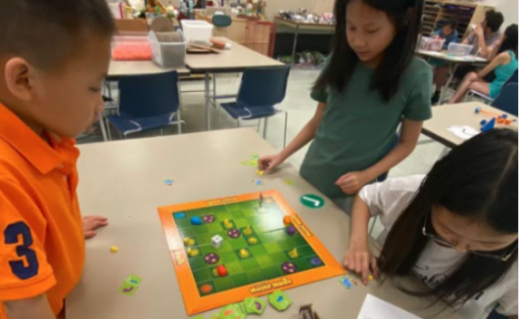 kids around a table playing a game