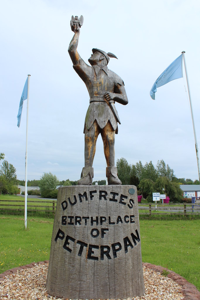 statue of a man dressed as Peter Pan standing on a plinth with the text Dumfries birthplace of Peter pan