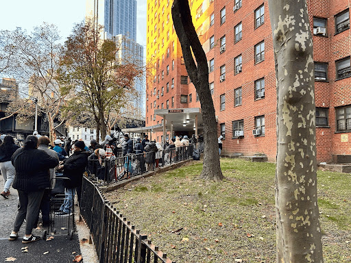 Residents of Grant Houses wait in line for food pantry distribution. 