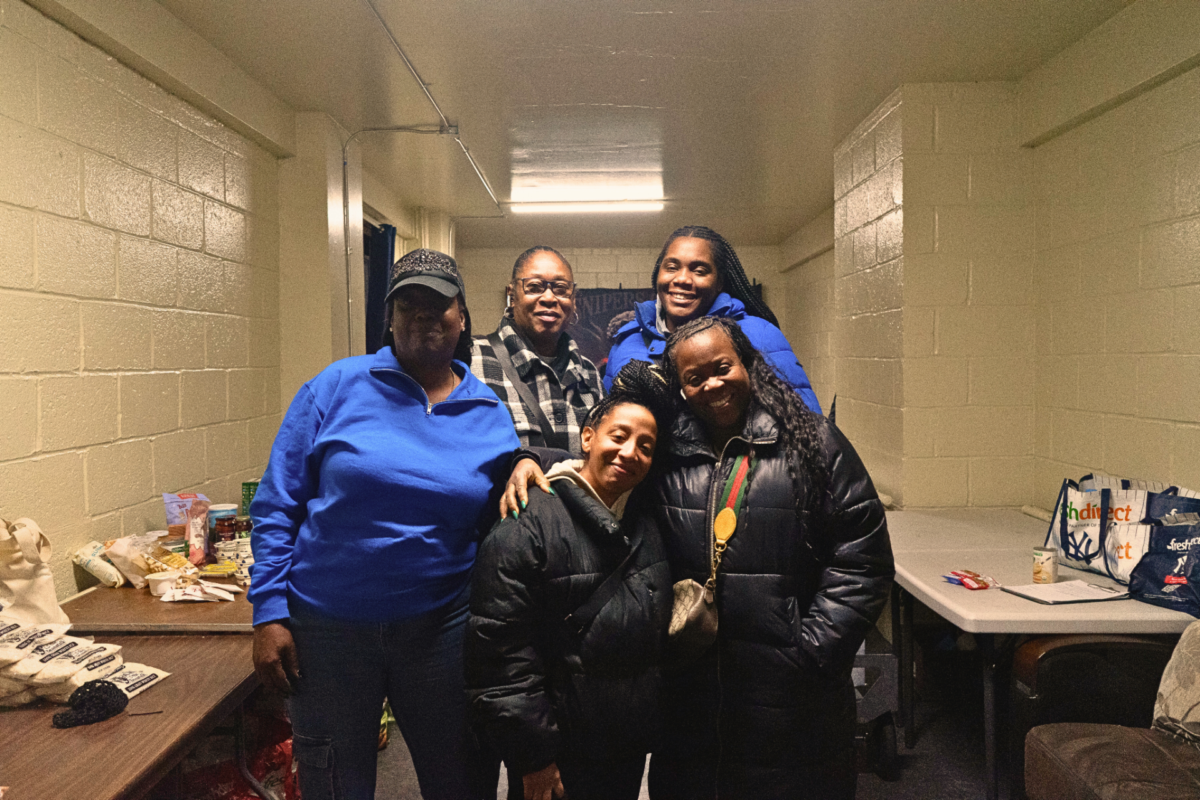 Chebella Hayward (left) stands with members of the Grant Food Pantry team.