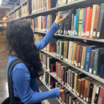 Sadie searches for a book in the Hunter College Library. (Photo credit: John Birt)