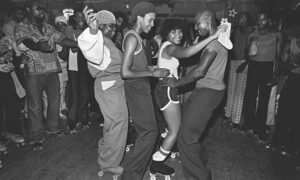 3 men and a woman in the center of a dance circle.