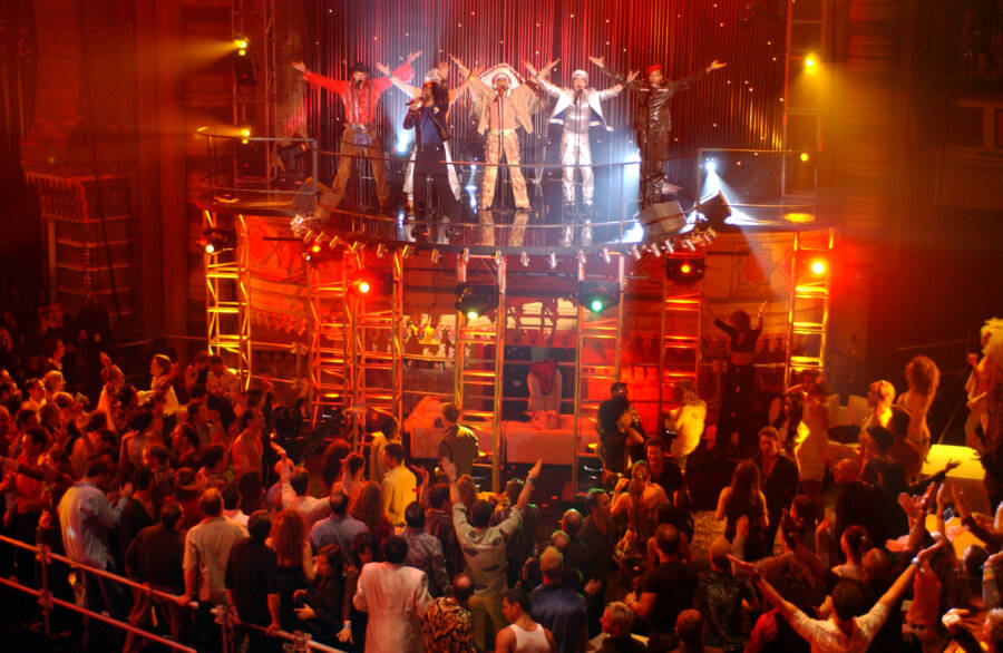 Clubgoers perform the "YMCA" dance alongside Village People. The song and dance became an enormous hit.